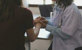 Cropped shot of a female nurse hold her senior patient's hand. Giving Support. Doctor helping old patient with Alzheimer's disease. Female carer holding hands of senior man photo