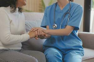 Cropped shot of a female nurse hold her senior patient's hand. Giving Support. Doctor helping old patient with Alzheimer's disease. Female carer holding hands of senior man photo