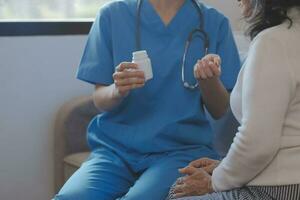 Cropped shot of a female nurse hold her senior patient's hand. Giving Support. Doctor helping old patient with Alzheimer's disease. Female carer holding hands of senior man photo