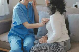 Cropped shot of a female nurse hold her senior patient's hand. Giving Support. Doctor helping old patient with Alzheimer's disease. Female carer holding hands of senior man photo