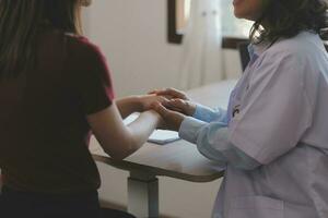 Cropped shot of a female nurse hold her senior patient's hand. Giving Support. Doctor helping old patient with Alzheimer's disease. Female carer holding hands of senior man photo