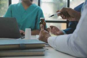 Team of doctors and businesswoman having a meeting in medical office photo