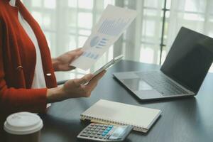 Audit concept,Administrator business man financial inspector and secretary making report calculating balance. Internal Revenue Service checking document. photo