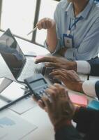 Financial analysts analyze business financial reports on a digital tablet planning investment project during a discussion at a meeting of corporate showing the results of their successful teamwork. photo