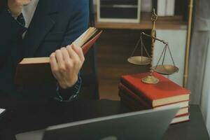 Business and lawyers discussing contract papers with brass scale on desk in office. Law, legal services, advice, justice and law concept picture with film grain effect photo