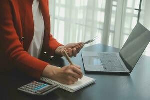 Audit concept,Administrator business man financial inspector and secretary making report calculating balance. Internal Revenue Service checking document. photo