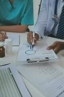 Concentrated medical team using laptop together in the office photo