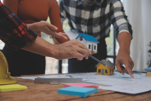 Construction and structure concept of engineer working drawing on blueprint meeting for project working with partner on model building and engineering tools in working site, construction concept. photo