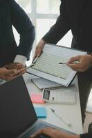 Financial analysts analyze business financial reports on a digital tablet planning investment project during a discussion at a meeting of corporate showing the results of their successful teamwork. photo