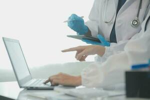 Health care researchers working in life science laboratory. Young female research scientist and senior male supervisor preparing and analyzing microscope slides in research lab. photo