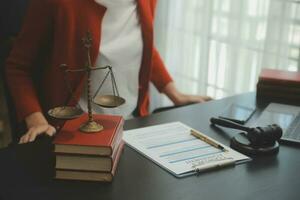 Business and lawyers discussing contract papers with brass scale on desk in office. Law, legal services, advice, justice and law concept picture with film grain effect photo