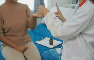 Doctor use stethoscope, checking up heart beat, lunch of auscultation in doctor office at hospital. Patient worker has to get medical checkup every year for her health or medical checkup cardiologist photo