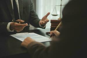 Business and lawyers discussing contract papers with brass scale on desk in office. Law, legal services, advice, justice and law concept picture with film grain effect photo