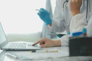 Health care researchers working in life science laboratory. Young female research scientist and senior male supervisor preparing and analyzing microscope slides in research lab. photo