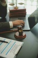 Business and lawyers discussing contract papers with brass scale on desk in office. Law, legal services, advice, justice and law concept picture with film grain effect photo