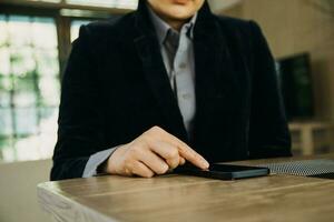 Mature businessman using a digital tablet to discuss information with a younger colleague in a modern business lounge photo