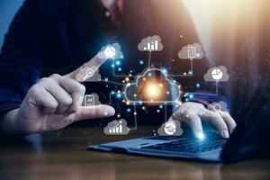 man use Laptop with cloud computing diagram show on hand. Cloud technology. Data storage. Networking and internet service concept. photo