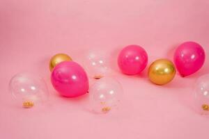 Group of multicolored transparent, pink and gold balloons lying on the floor in the house for Valentine's Day, Birthday, holiday concept photo