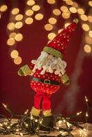 a santa claus figurine on a red background photo