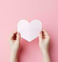 Woman holding pink heart card photo