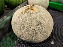 Photo fresh melon for sale in the supermarket. Cantaloupe.