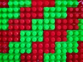 Abstract background pattern of colored building blocks top view. Pattern of plastic part of constructor block puzzle. photo