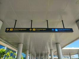 Airport signboard in Indonesia. Departures direction signboard. photo