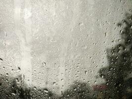 Abstract background of drops of water flow down at windshield. photo