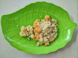 Moldy rice or rotten rice on a green plate photo