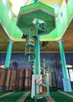 Traditional spiral stairs made of wood, painted green color in mosque photo