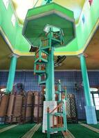 Traditional spiral stairs made of wood, painted green color in mosque photo