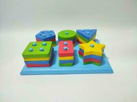 Educational toy for kindergarten isolated on white background. Geometric montessori toy photo