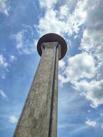 Minaret mosque against blue sky during day. Minaret or mosque tower is a typical architecture with tower-like structures. photo