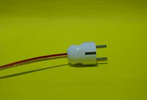 Close up of electrical plug socket isolated on yellow background photo