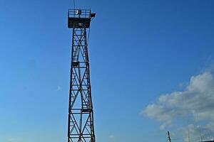 The ferry tower. Spotlight tower. lookout tower. is located at the harbor, near river. photo