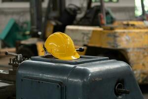 Yellow helmet with machinery, the background is factory photo