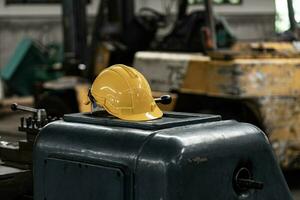 Yellow helmet with machinery, the background is factory photo