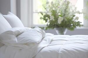 Beautiful luxury comfortable white pillow and blanket on bed decoration. Luxury white down comforter concept by photo