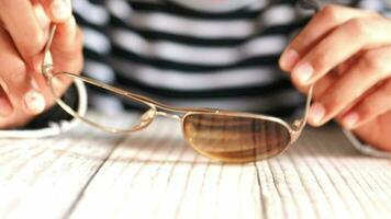 a person is holding a pair of sunglasses video