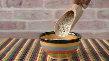 a person is pouring oats into a bowl video