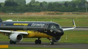 DUSSELDORF, GERMANY JULY 22, 2017 - Eurowings Airbus 320 D AIZR Borussia Dortmund livery taxiing before departure. Dusseldorf airport video