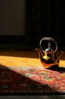 Oriental Teapot on Carpeted Floor photo