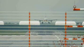 Widebody airplane approaching before landing at rainy weather in Dusseldorf Airport video