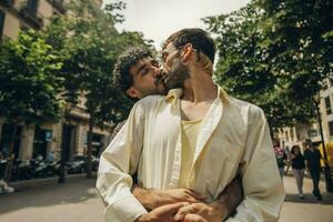 Happy gay couple kissing in the park. LGBT gay couple concept. photo