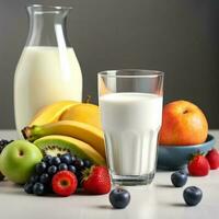 glass of milk in the table with fresh of fruits photo