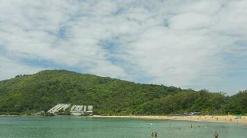 Tourists swim in the sea. Summer day panorama on a tropical island. People are relaxing on the beach. video