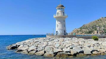 Leaving the port of alanya turkey traveling besides light house with cyty view and water video