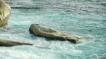 Turquoise waves rolled on the rocks, beach of Koh Miang island, Similan Islands, slow motion video