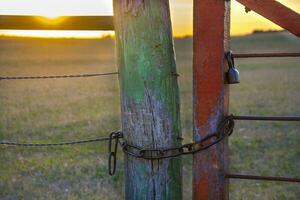 a chain is attached to a fence post photo