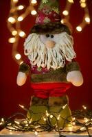 a santa claus doll with a beard and hat photo